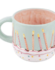 Mug with birthday cake design featuring candles and a pink interior on a white background