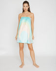 Woman wearing a spa wrap with a gradient design on a white background