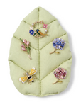 Assortment of Enchanted Brooch Pins on green leaf.