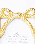 Gold bow-shaped picture frame on a white background