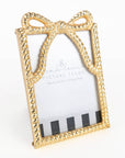 Gold bow-shaped picture frame on a white background