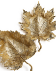 Two metallic gold leaf-shaped decorative wall pieces with detailed vein patterns, shown on a plain white background.