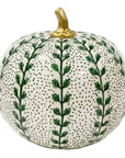 A decorative ceramic pumpkin with a white glazed base, covered in green leafy vine patterns and small black dots, featuring a metallic gold stem.