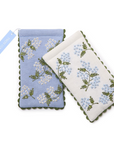 Two embroidered eye glasses holders with floral patterns on a white background