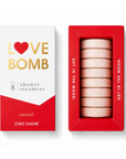 Chez Gagné 'Love Bomb' santal shower steamers set, showing the white and red outer packaging alongside the red inner tray containing eight pale pink steamers.