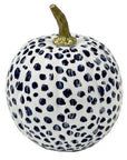 A decorative pumpkin with a white base covered in dark navy blue leopard-like spots, featuring a metallic gold stem on a plain white background.