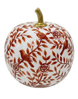 A decorative ceramic pumpkin with a white base decorated with a brown floral and bird pattern, featuring three small birds and a gold-colored stem.