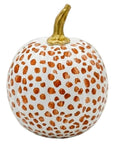 A decorative faux pumpkin with a white base, covered in hand-painted copper-brown spots, and a metallic gold stem, shown on a plain white background.