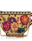 Beaded handbag with floral designs and a gold chain on a white background