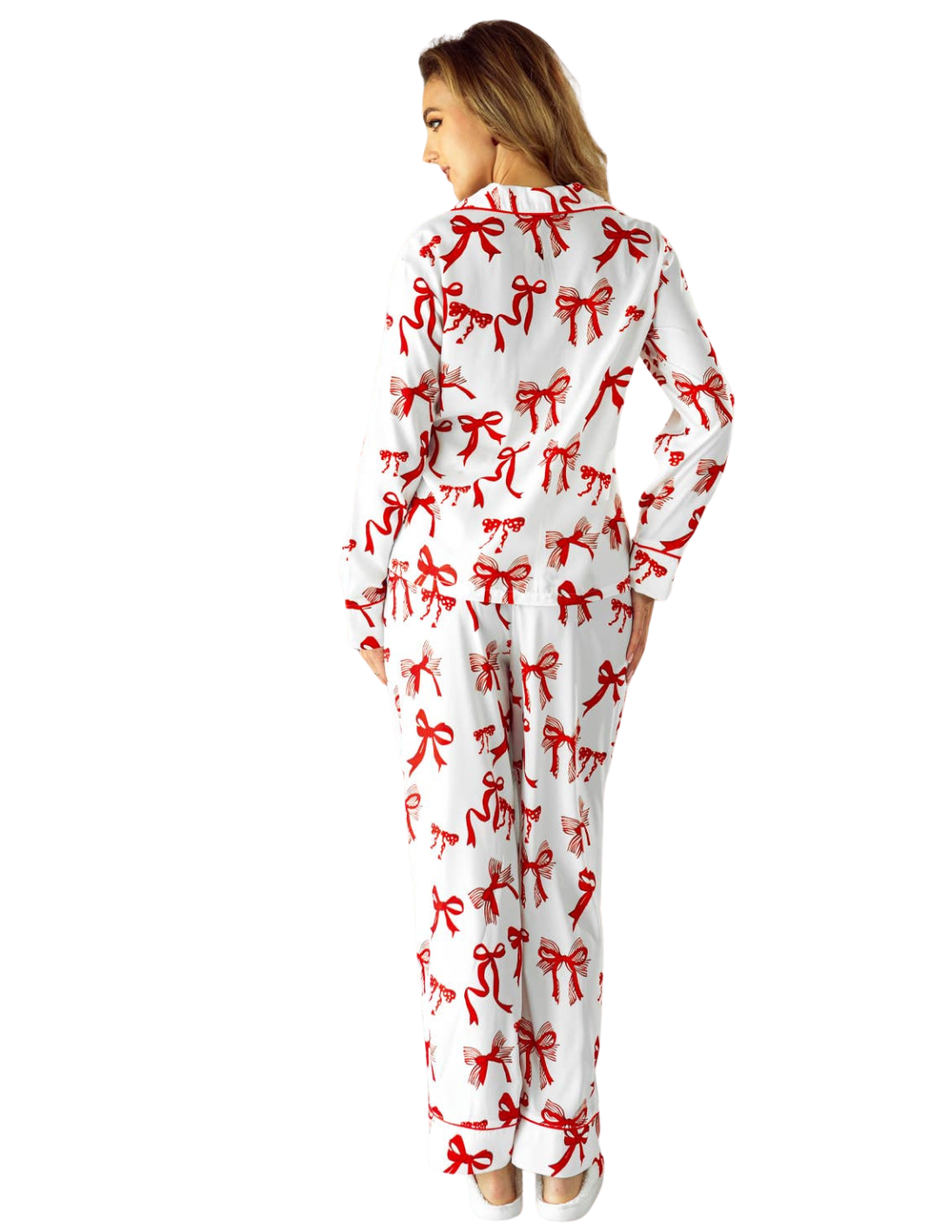 Person wearing a white onesie with red bow patterns on a white background