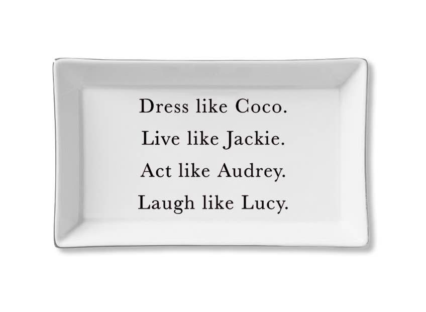 A white ceramic tray with black text that reads: 'Dress like Coco. Live like Jackie. Act like Audrey. Laugh like Lucy.'