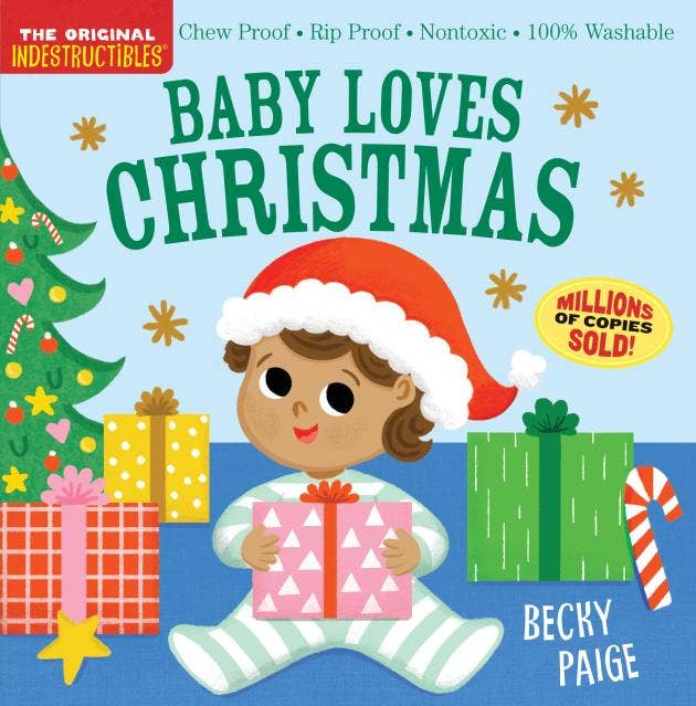 Front cover of the children's board book 'Baby Loves Christmas' by Becky Paige, featuring a cartoon baby in a Santa hat holding a gift box, surrounded by Christmas trees, wrapped presents, and candy canes on a light blue background.