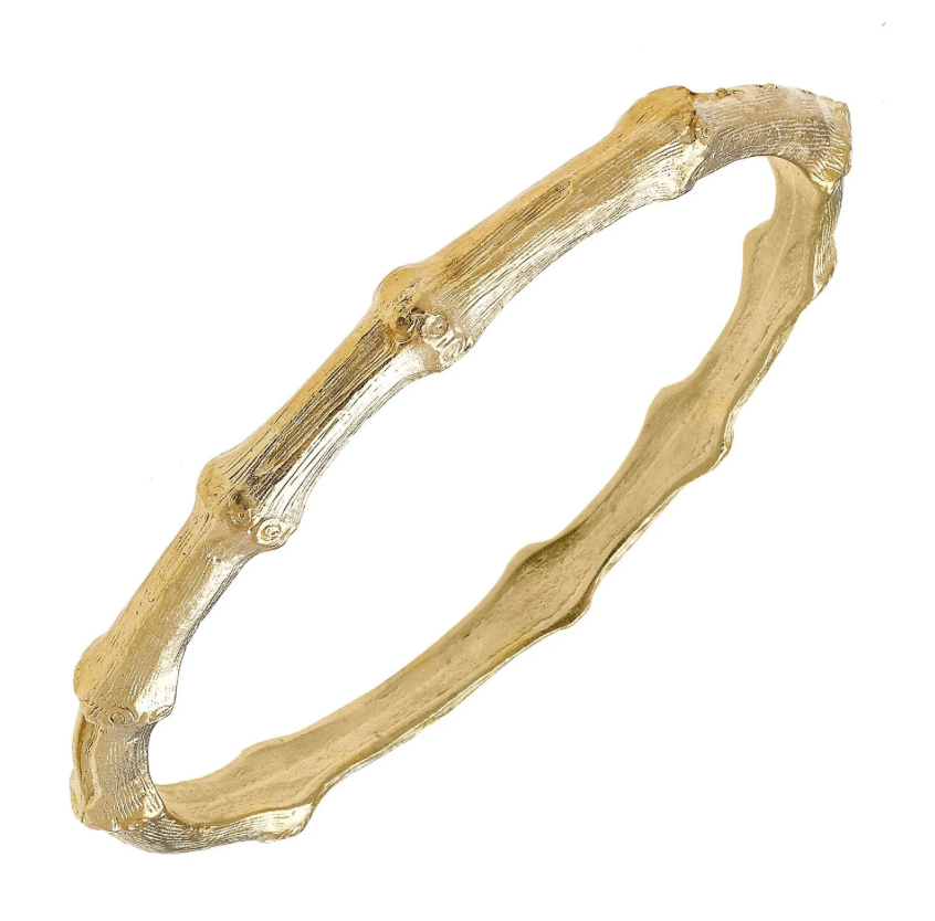 A gold bamboo bangle bracelet with a refined, natural charm.