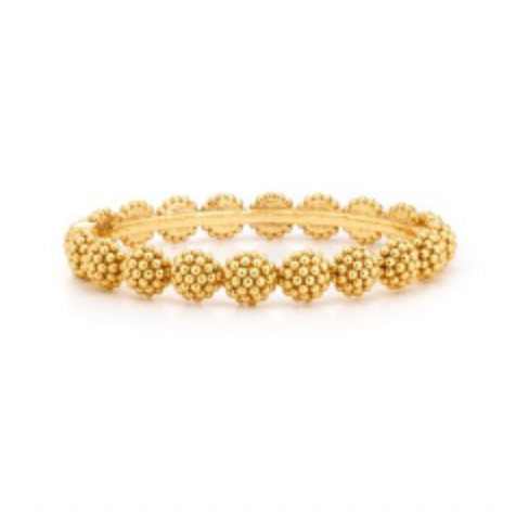 A gold-colored hinged bangle bracelet with a series of round charms linked together.