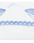 White baby outfit with blue checkered details on a white background