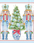 Cocktail napkins with nutcrackers and a Christmas tree on a light blue background