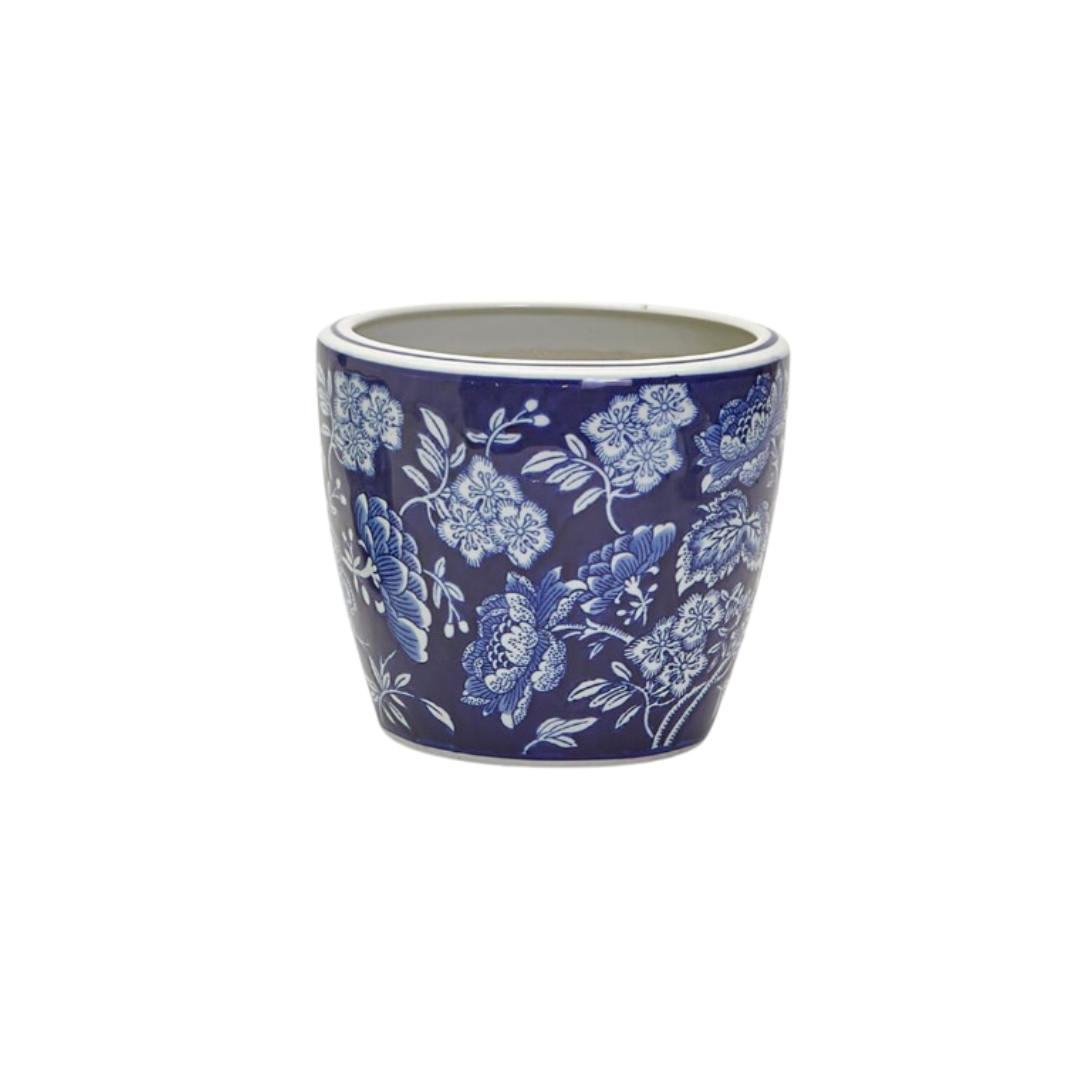 A large blue and white hand painted porcelain planter with a floral pattern.
