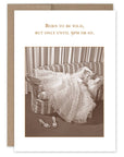 A birthday card with a vintage photo of a woman lying on a couch, with text above her figure. The card has a beige border and is blank inside.