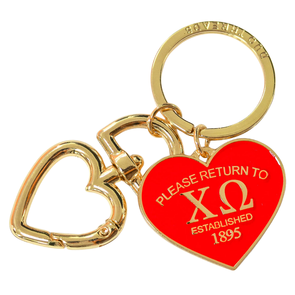Keychain with red heart-shaped tag and gold heart charm on a white background