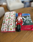 Nutcracker ornament, nutcracker cocktail napkins and a Christmas towel.