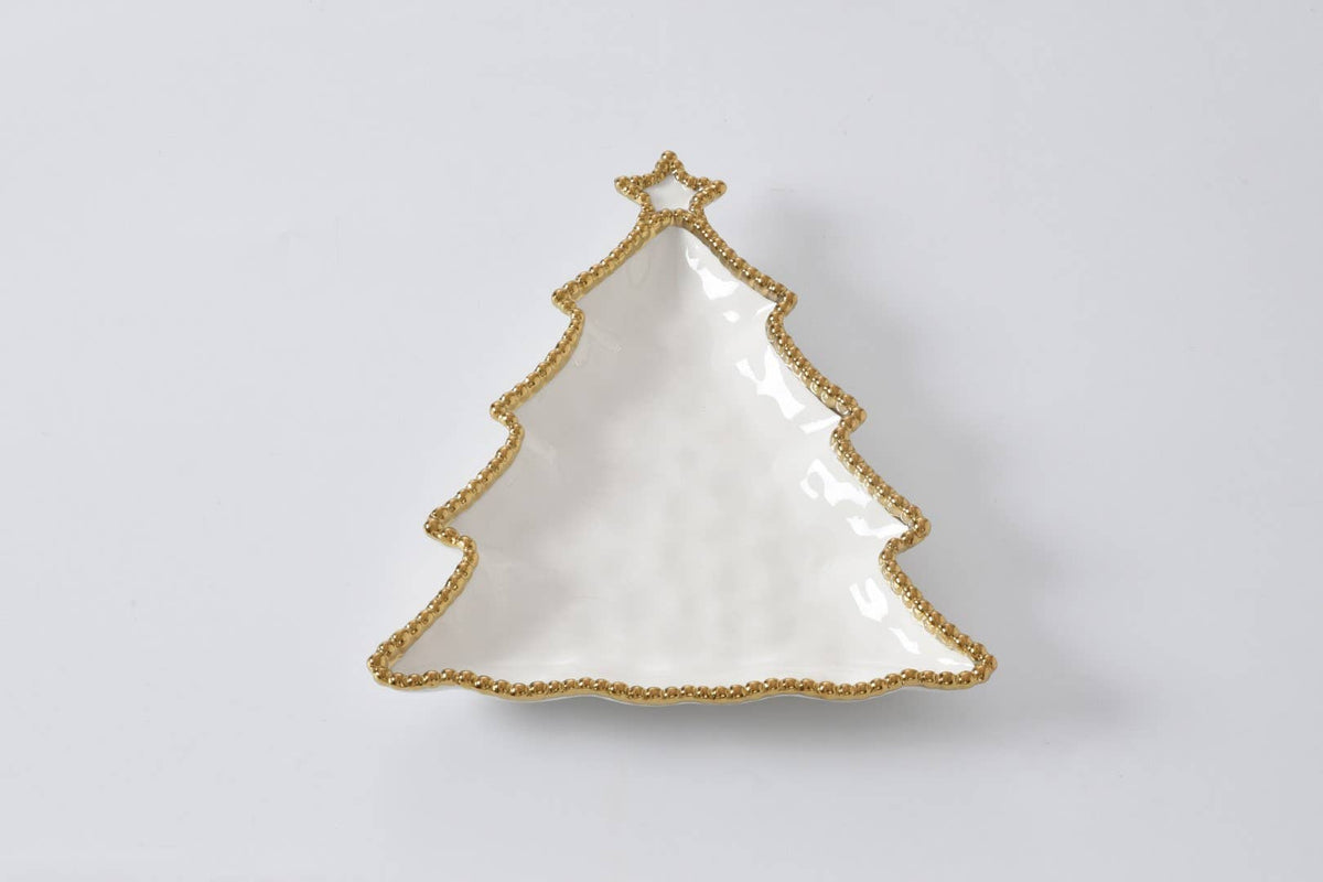White Christmas tree-shaped dish with gold trim on a light gray background