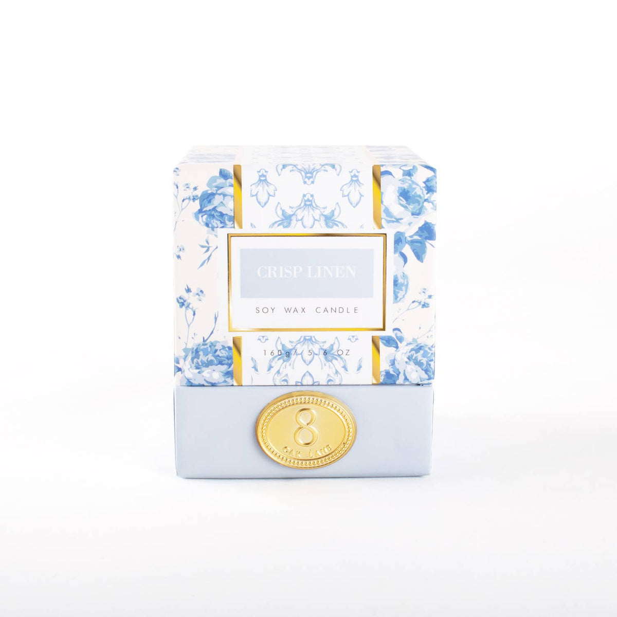 A Crisp Linen scented soy wax candle in a frosted glass container with a floral pattern and a gold-colored lid.