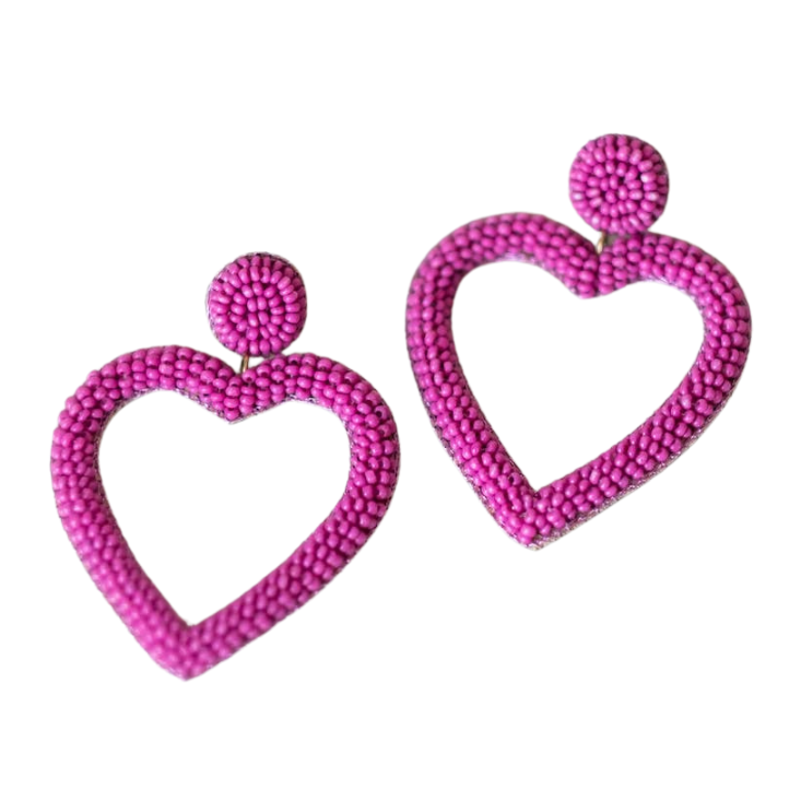 A pair of pink heart-shaped beaded earrings on a white background