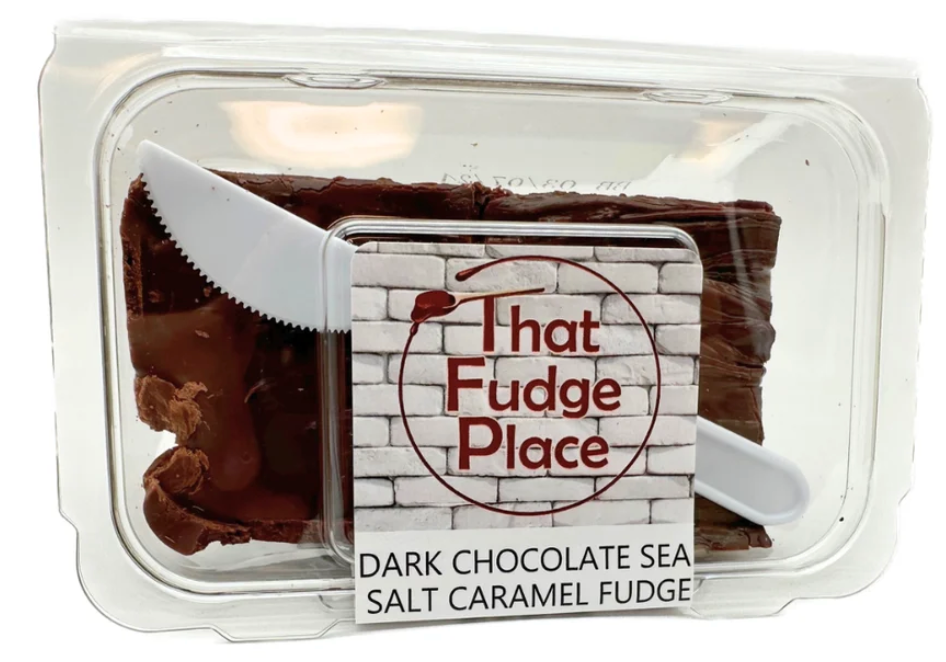 Plastic container with That Fudge Place label Dark Chocoate Sea Salt Caramel Fudge with plastic knife enclosed