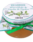 Jar of marmalade with a decorative label and green ribbon on a white background