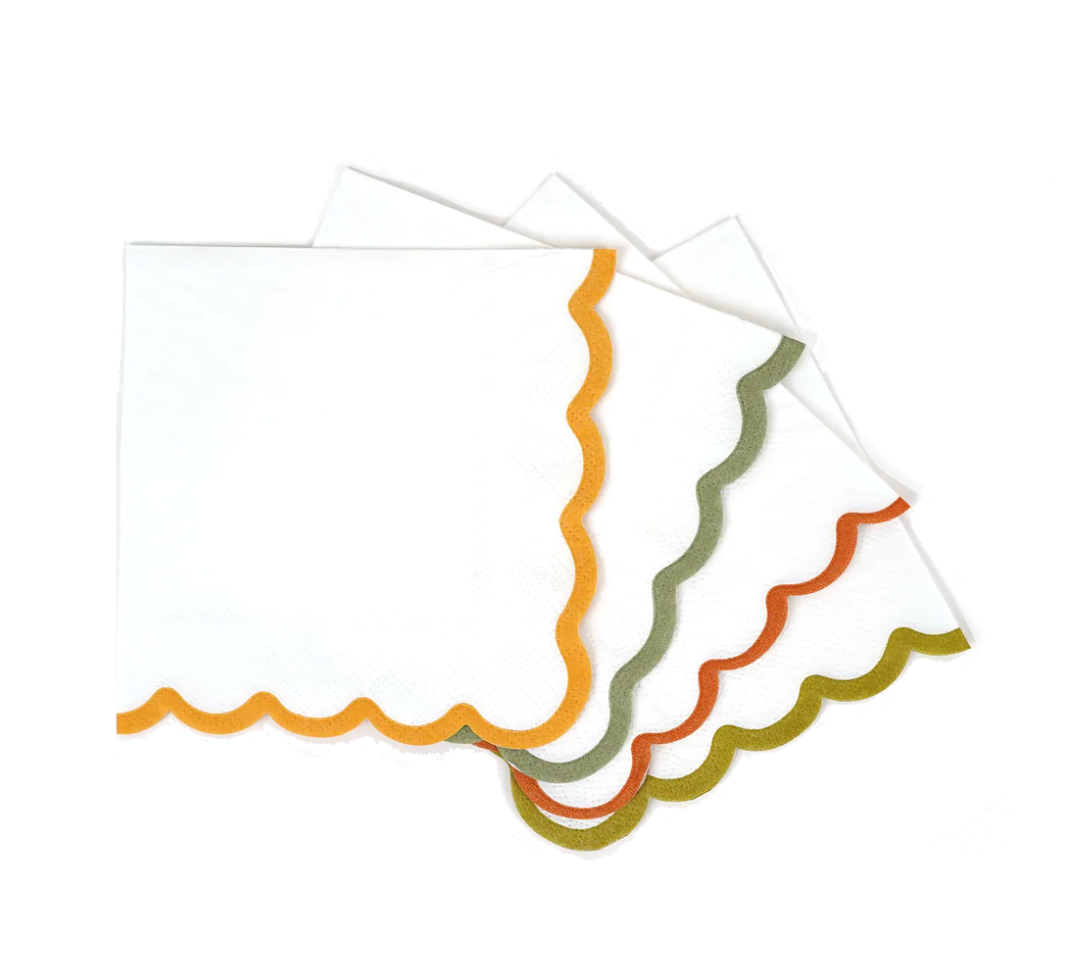 A set of scallop paper beverage napkins with colorful edges in orange, red, green, and yellow.