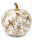 A decorative ceramic pumpkin with a white body, decorated with gold-toned floral branches and three small gold birds, topped with a gold stem, on a white background.