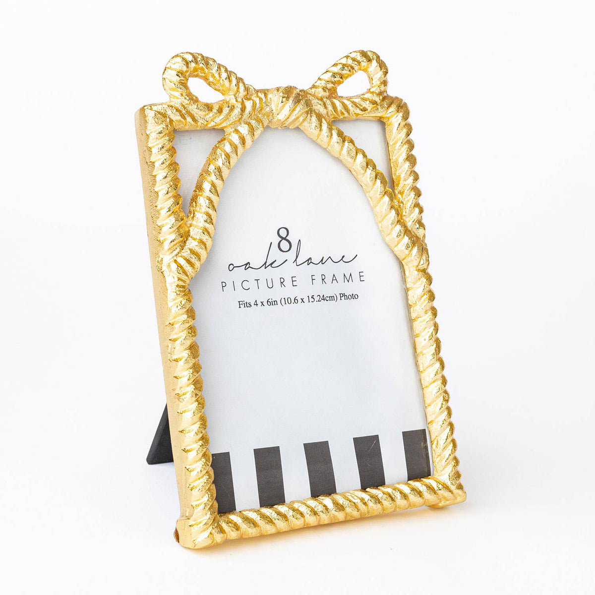 Gold picture frame with bow design on a white background