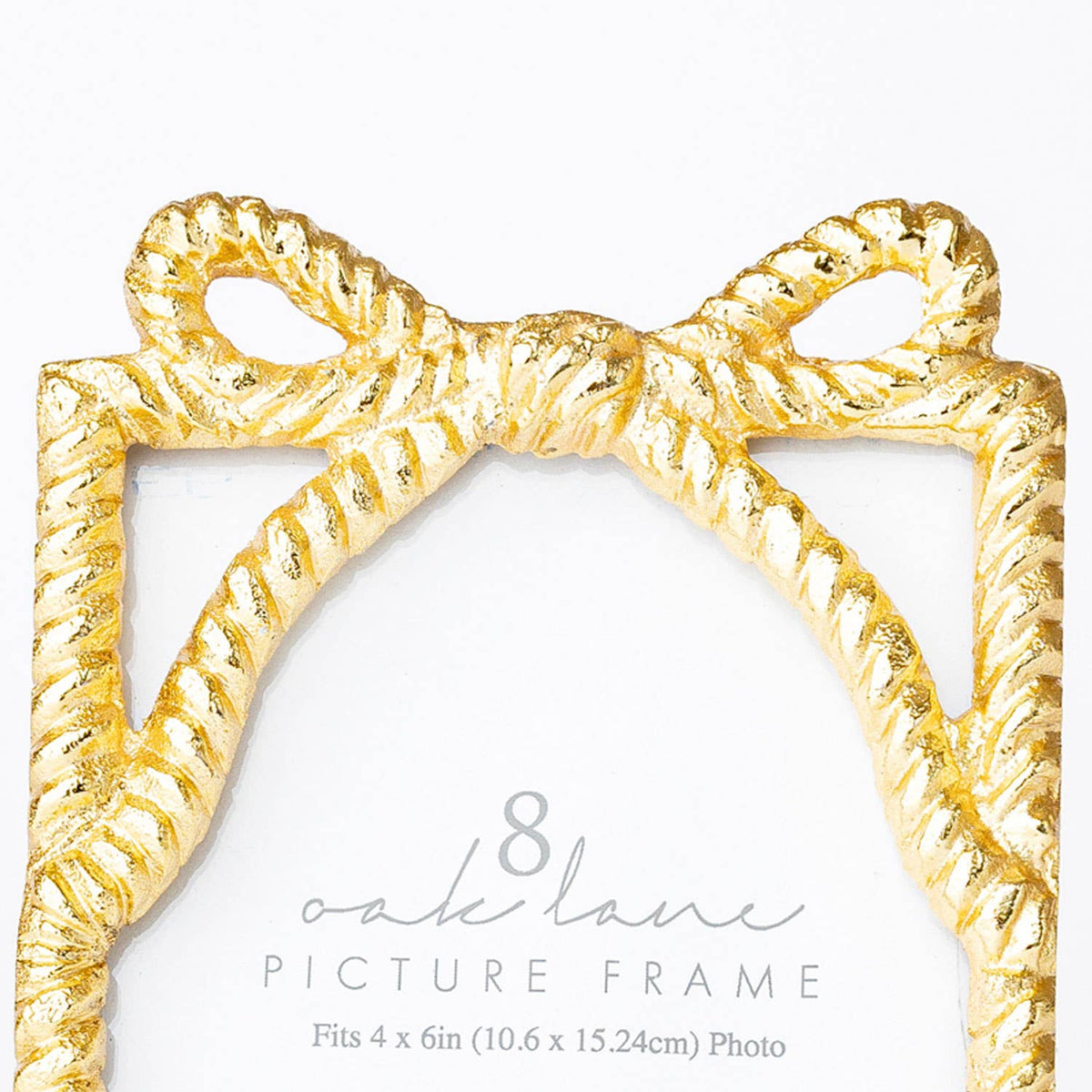 Gold bow-shaped picture frame on a white background