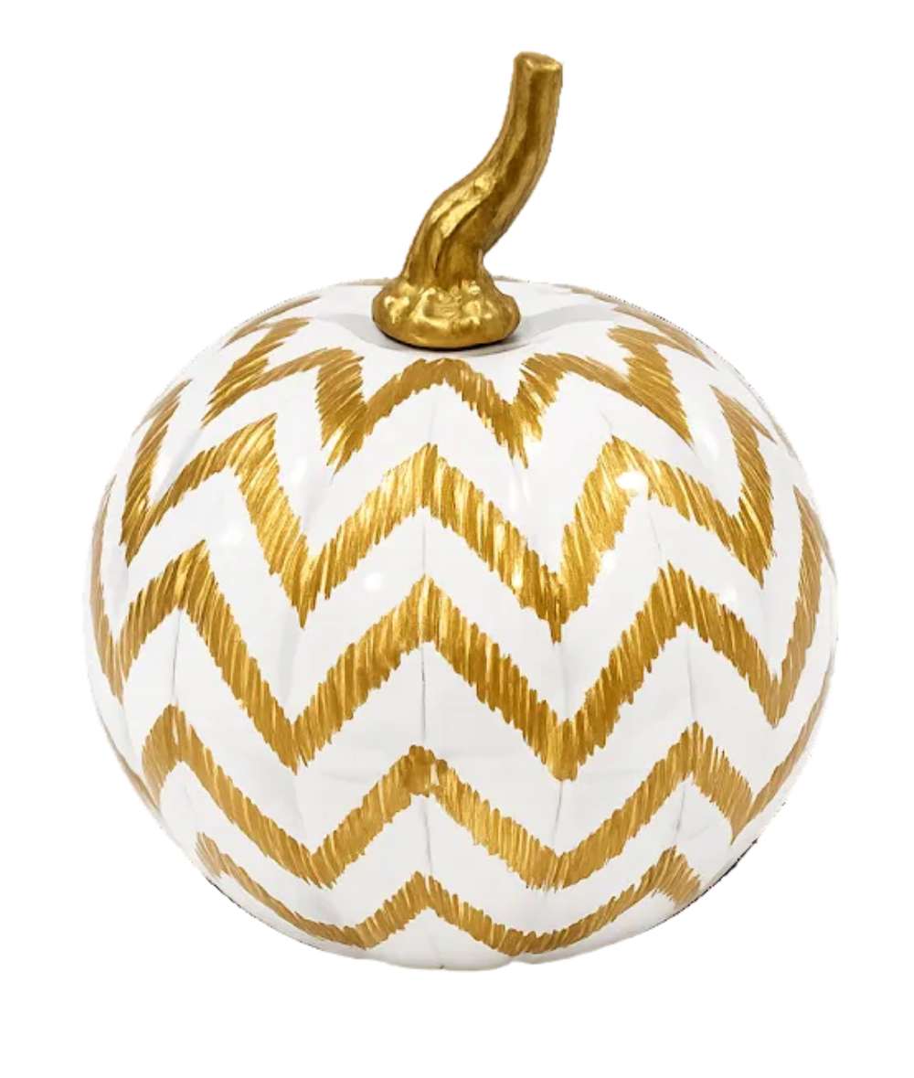 A decorative pumpkin with a white body featuring a metallic gold chevron pattern and a textured gold stem, isolated on a white background.