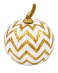 A decorative pumpkin with a white body featuring a metallic gold chevron pattern and a textured gold stem, isolated on a white background.