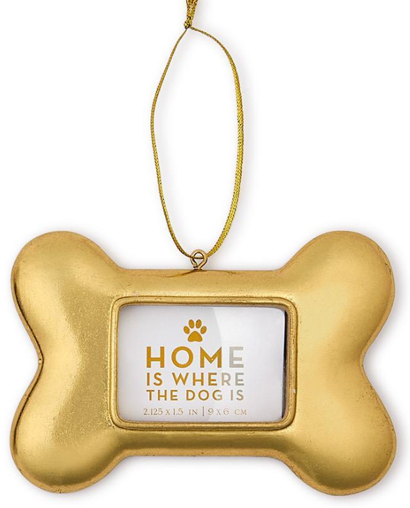 Gold dog bone frame ornament with gold string with statement in window stating "Home is where the dog is."