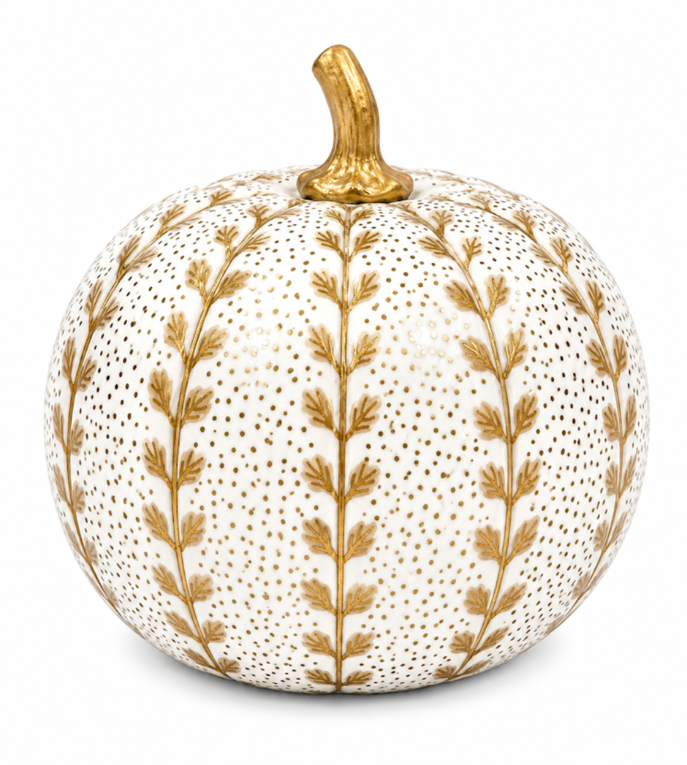 A decorative faux pumpkin with a textured white surface covered in tiny gold dots, featuring vertical gold leafy vine patterns and a metallic gold stem, set against a plain white background.