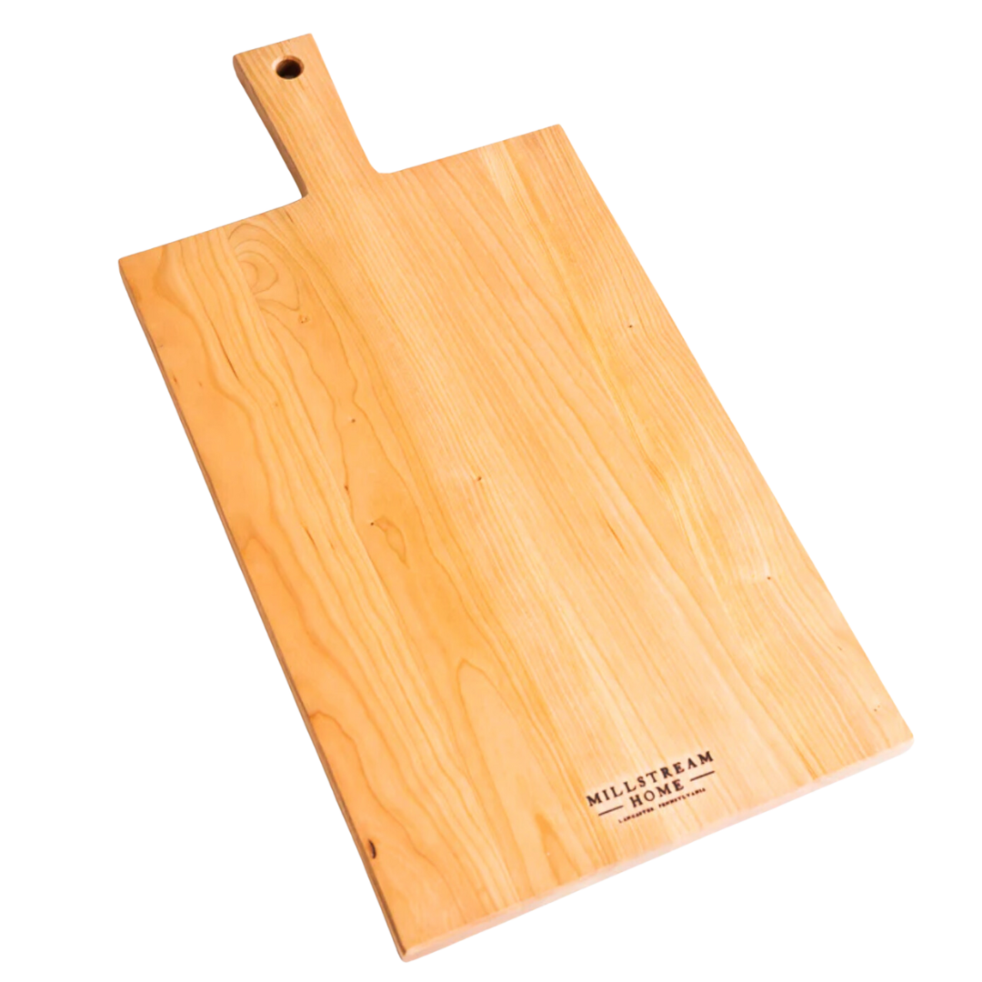 A flat, rectangular wooden cutting board with a natural finish and a logo imprinted on the corner.