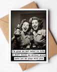 A humorous birthday card featuring two women holding drinks, with a text joke about mother's approval. The card comes with a brown envelope.