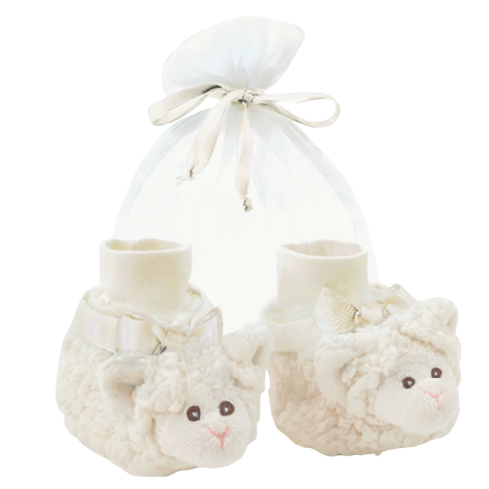 Pair of cream-colored baby booties with fluffy lambs on a white background
