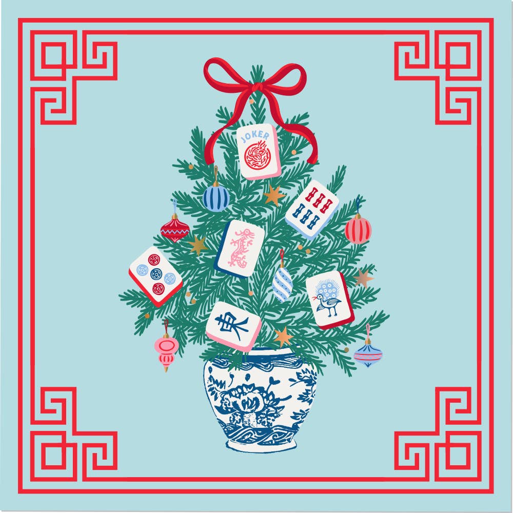 A festive illustrated Christmas tree decorated with red ornaments, blue-and-white patterned tiles, and a red bow, set in a blue-and-white porcelain pot on a light blue background with a red decorative border cocktail napkin.