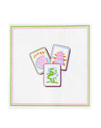 A square white paper napkin featuring a printed border of green and pink, with three illustrated playing card designs (Joker, pagoda, and dragon) centered on it, shown against a plain white background.