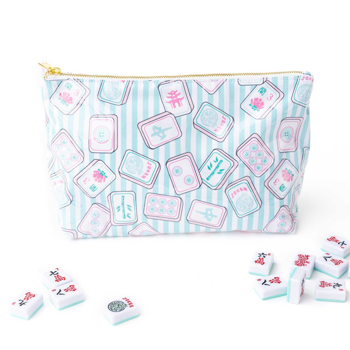 A zippered pouch with a light blue and white striped background and a repeating pattern of pink and white mahjong tiles, shown with small mahjong pieces scattered in front on a white background.
