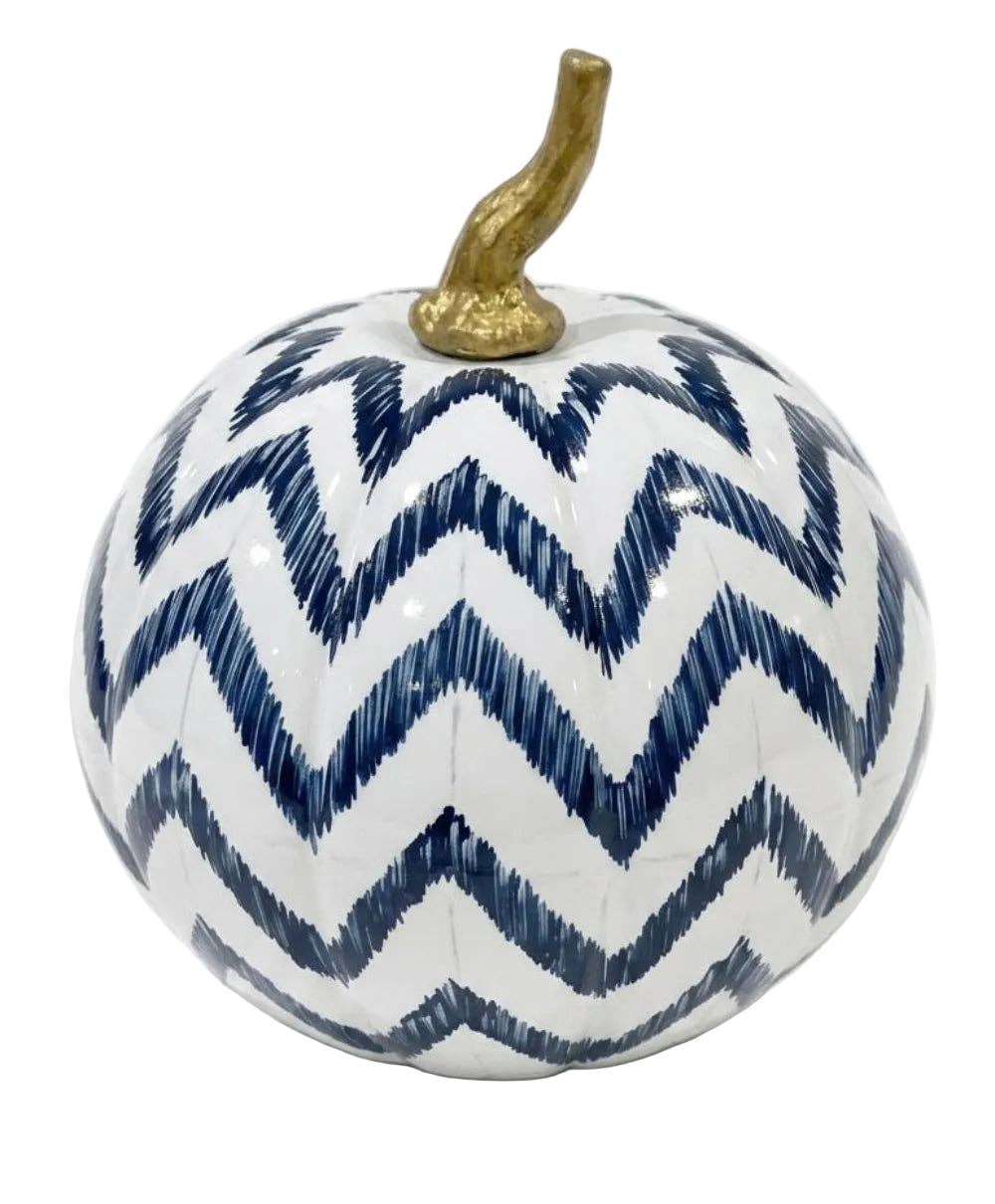 A decorative pumpkin with a white body, a navy blue chevron pattern, and a metallic gold stem, shown against a plain white background.