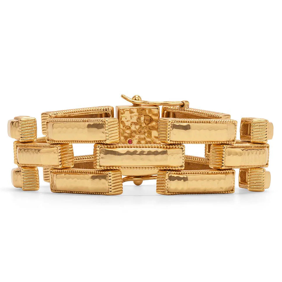 Gold bracelet with geometric design on a white background
