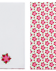 Two white dish towels shown side by side. The left napkin has a small embroidered poinsettia near the bottom.