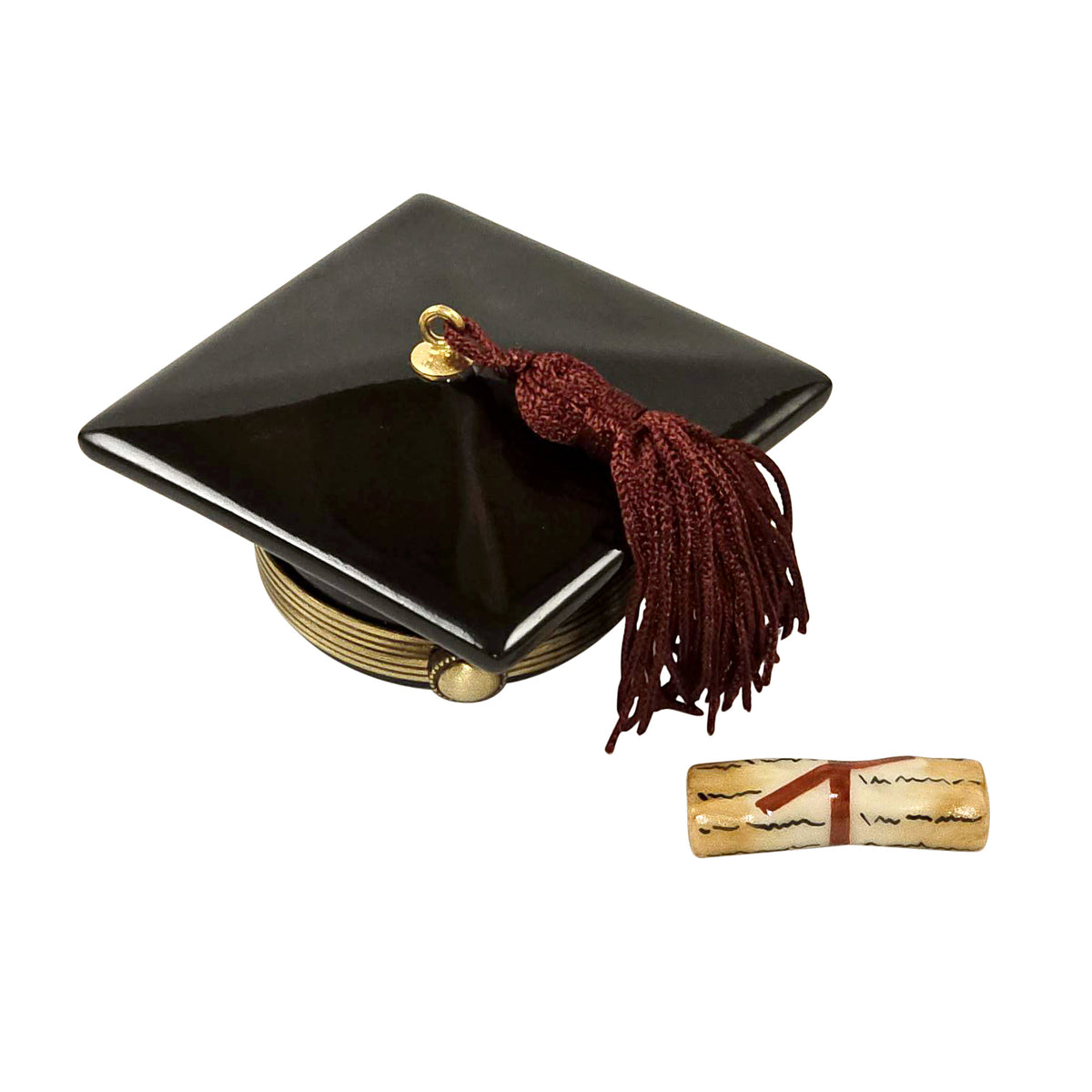 A hand painted porcelain Limoges box resembling a black graduation cap with a removable diploma box, depicting a gold tassel and a red and gold diploma.