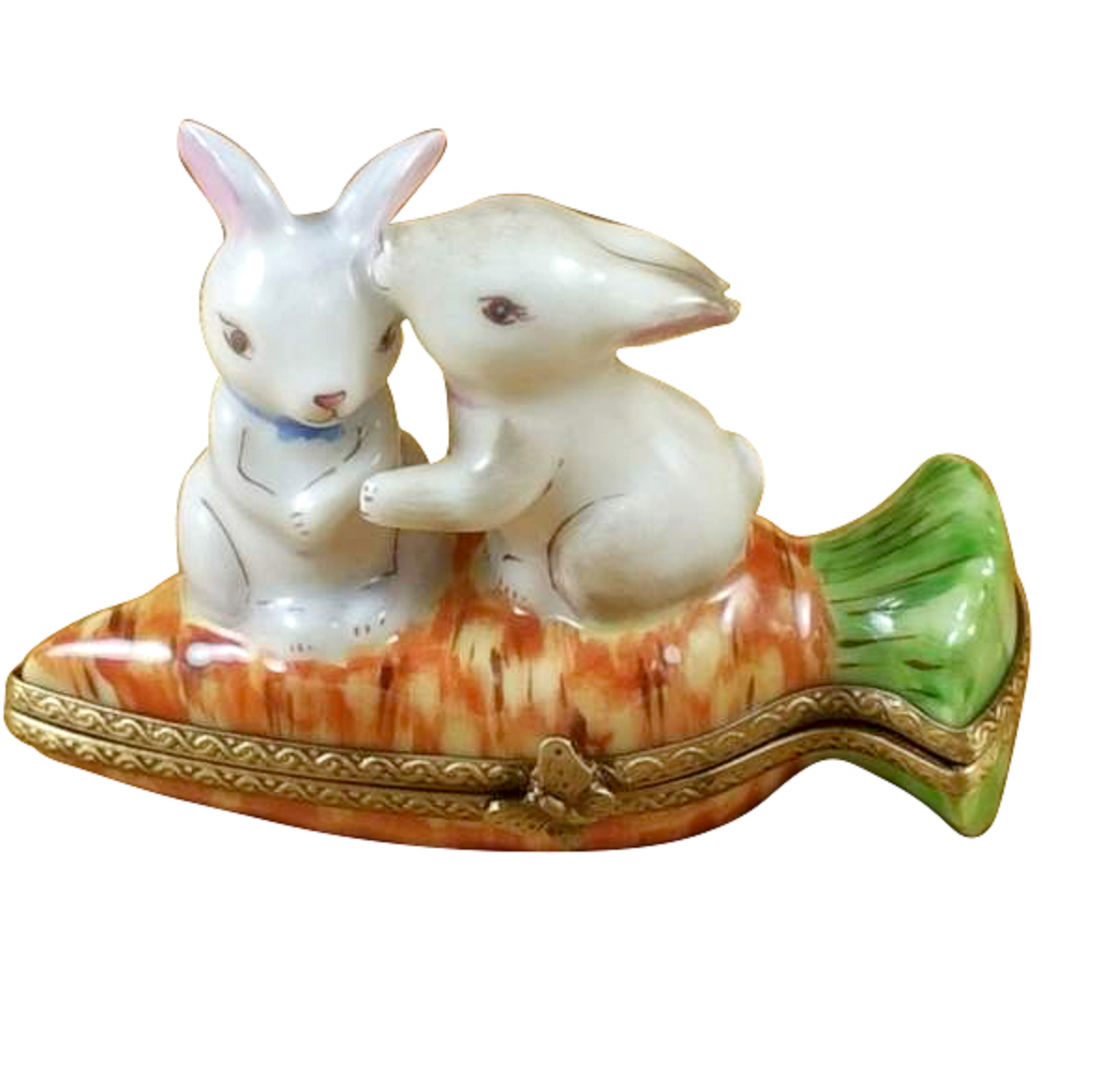 Decorative figurine of two rabbits on a carrot-shaped base with gold trim.