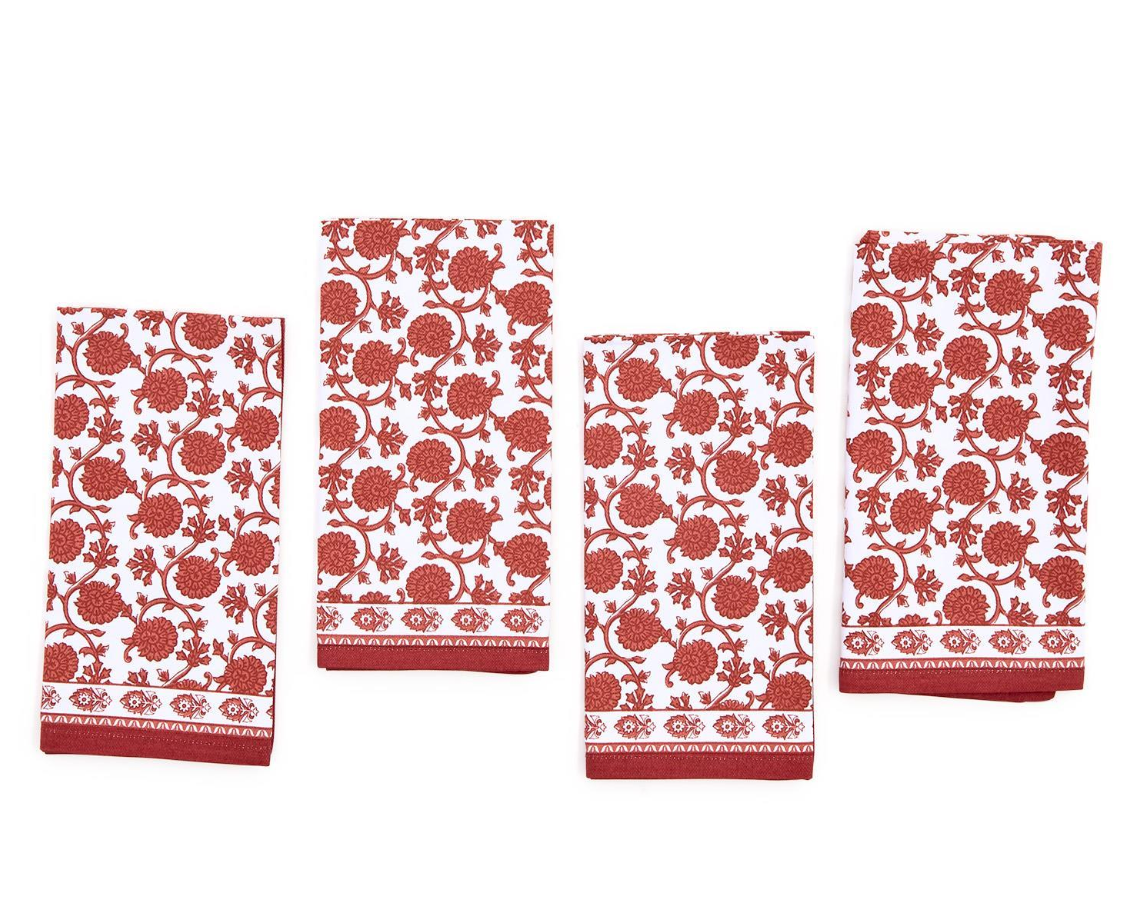 A set of four red and white floral patterned cloth napkins.