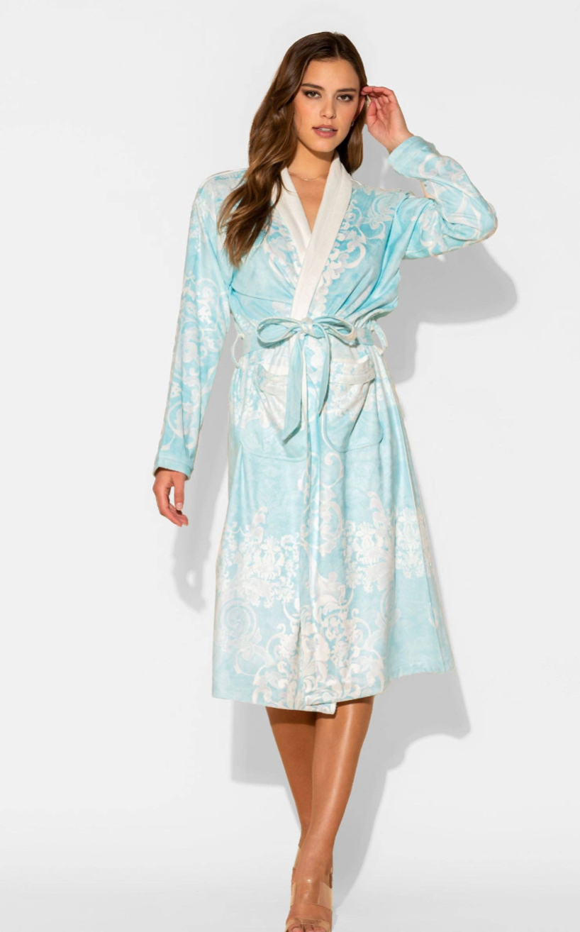 Woman wearing a light blue and white patterned robe on a white background